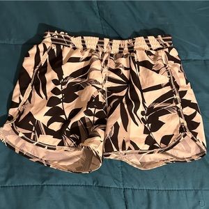 white shorts with black plants